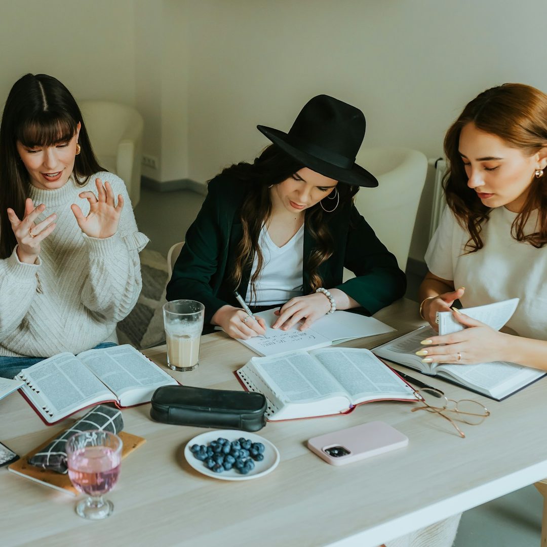 Four colleagues discussing a project in a modern office setting.