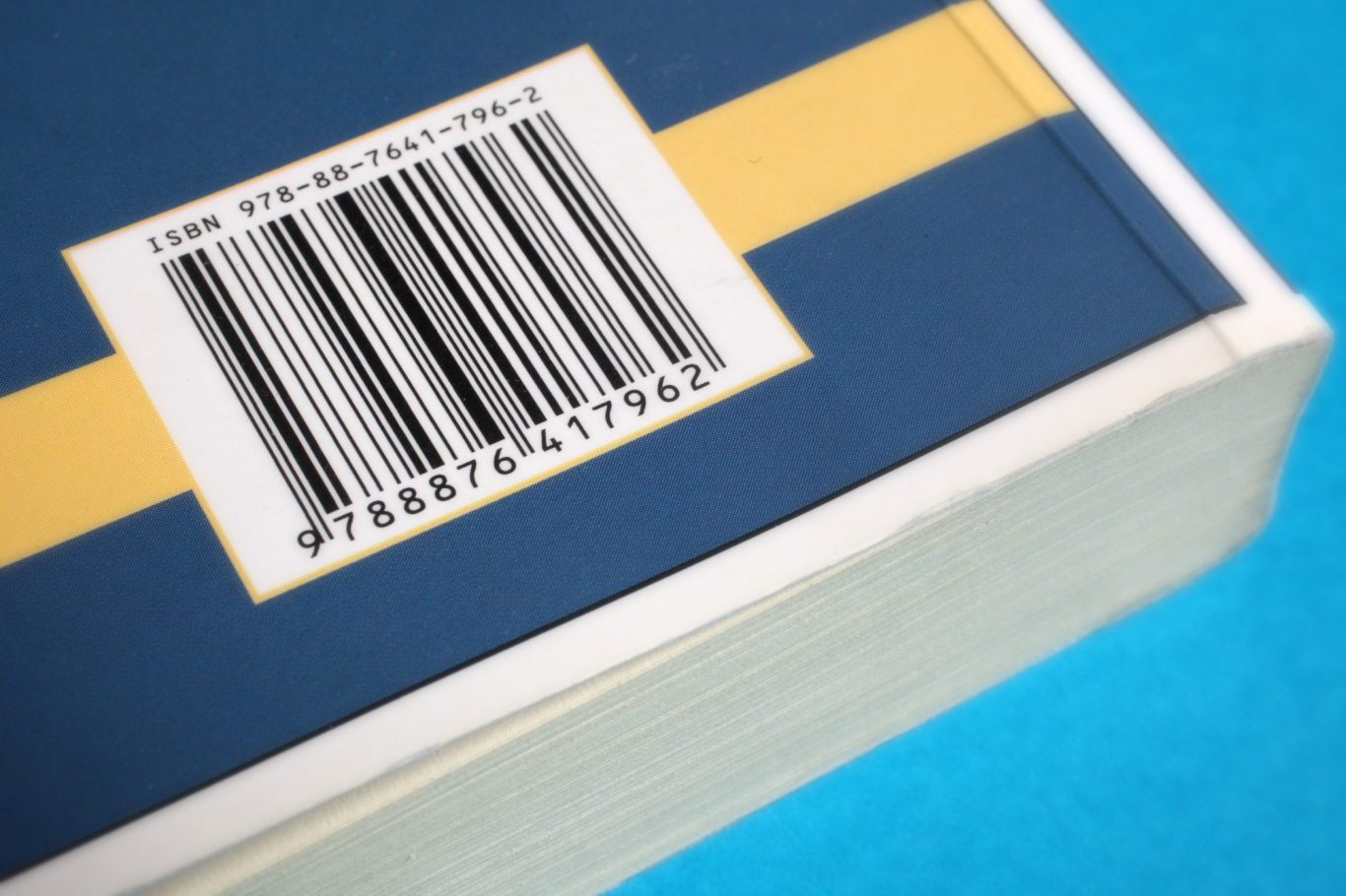 Close-up of a barcode on a blue and yellow packaging box.