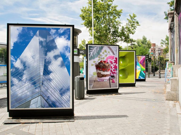 Billboards displaying colorful advertisements along a city street.