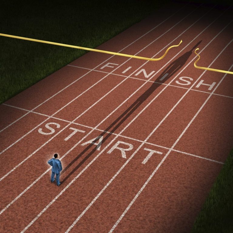 A runner stands on a track marked “START” and “FINISH,” with long shadows cast behind.