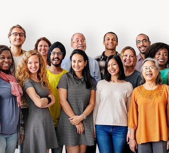 Diverse group of people smiling, standing together in a casual setting.