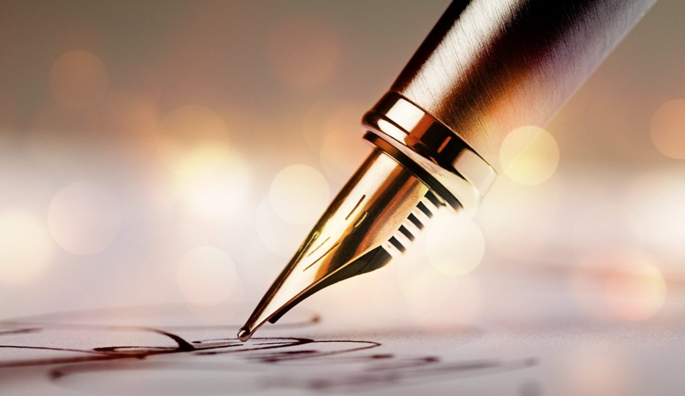 Birch & Ink — Writing Services Close-up of a fountain pen poised over handwritten notes with a blurred background.