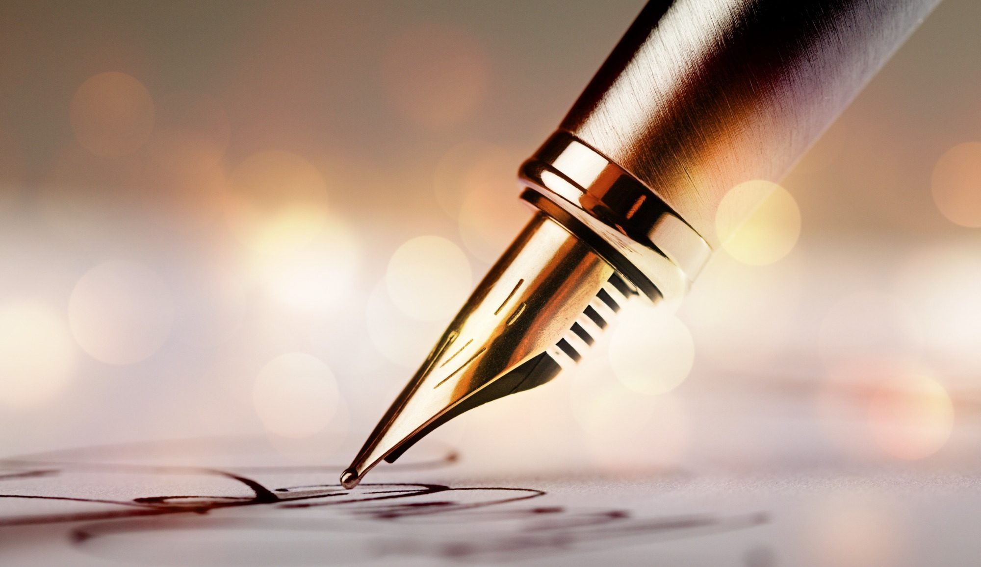 Close-up of a fountain pen poised over handwritten notes with a blurred background.