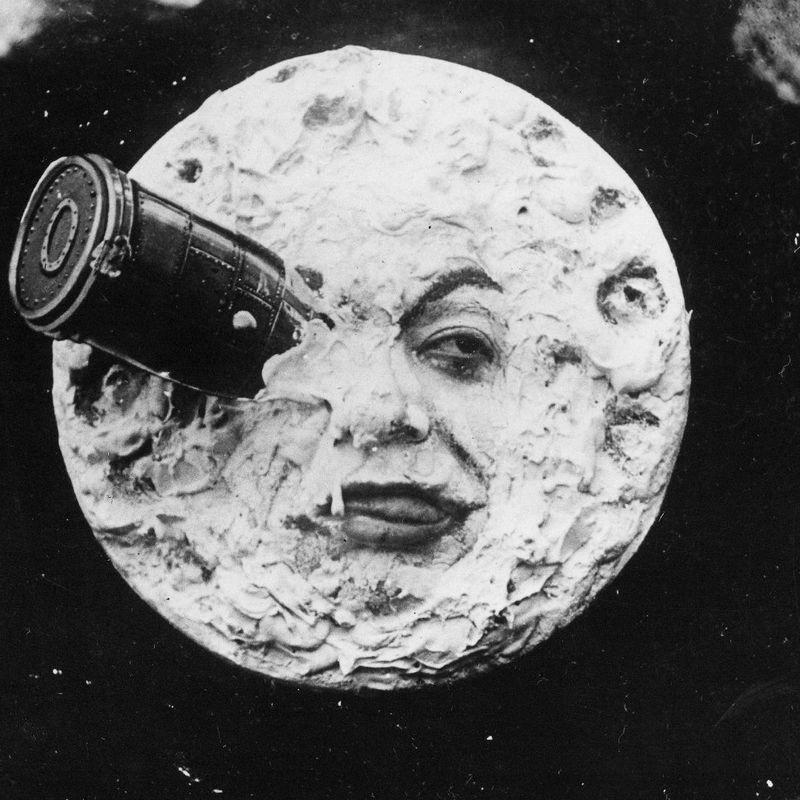 Image from the movie 'A Trip to the Moon'. 

A moon with a human face and a cannon aimed at it, reminiscent of early cinema.