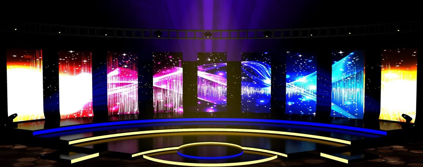 A vibrant stage setup with colorful displays and dramatic lighting effects.