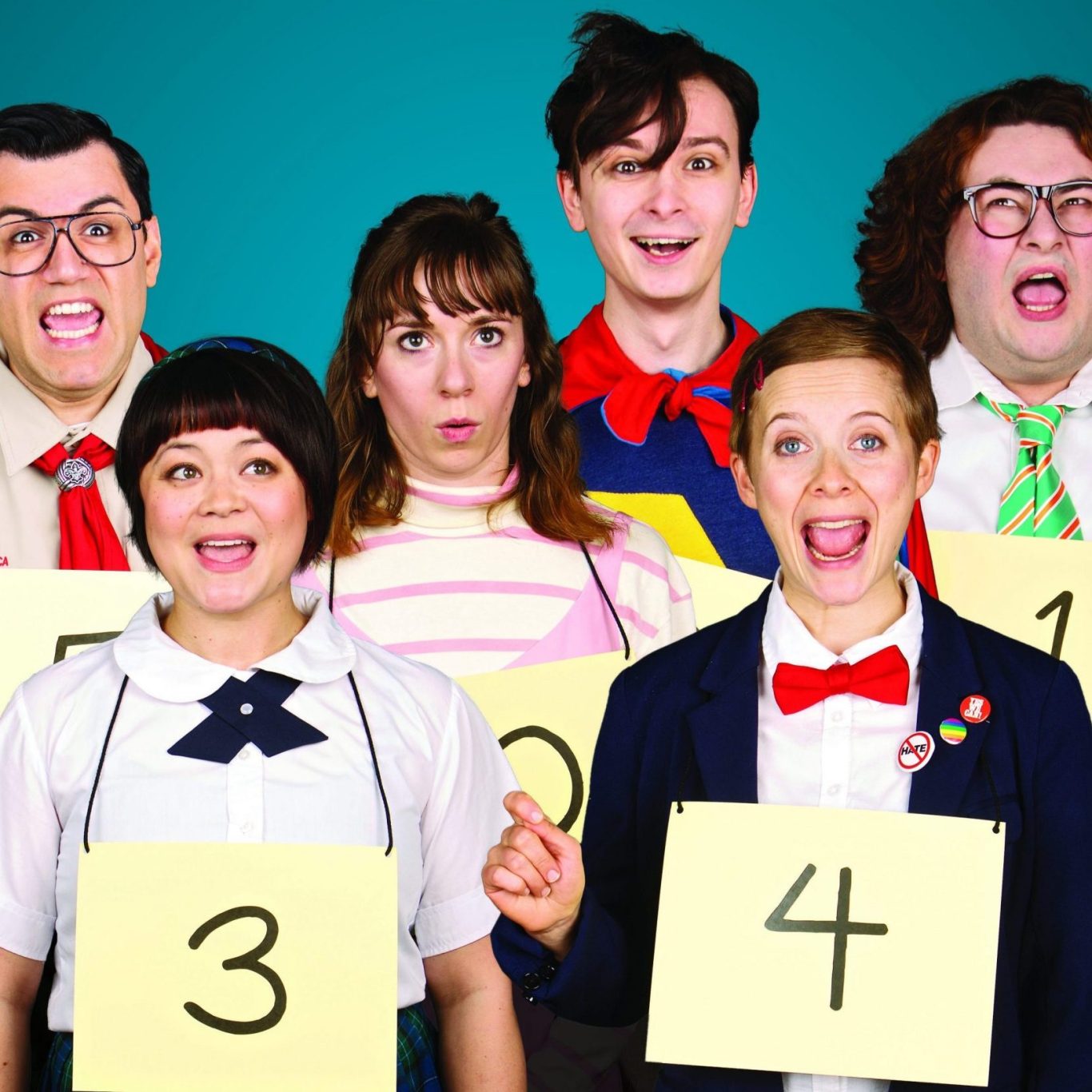 A group of six people holding number signs, all with surprised expressions.