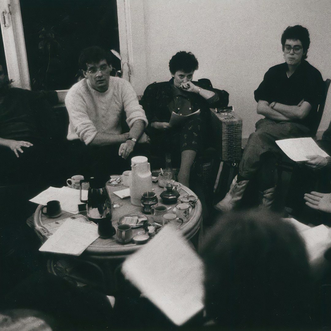 Four colleagues discussing a project in a modern office setting.