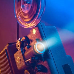 A vintage film projector with colorful lighting effects.