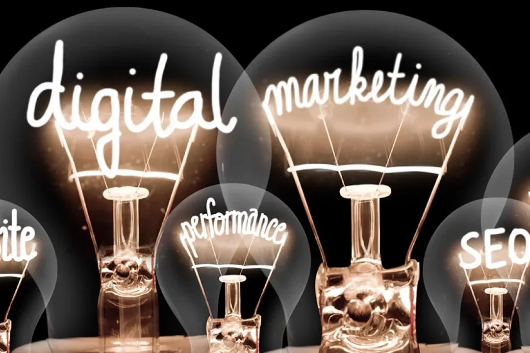 Bright light bulbs with text: "digital," "marketing," "SEO," and "performance" illuminated.