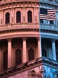 United States Capitol building with an American flag waving in front.