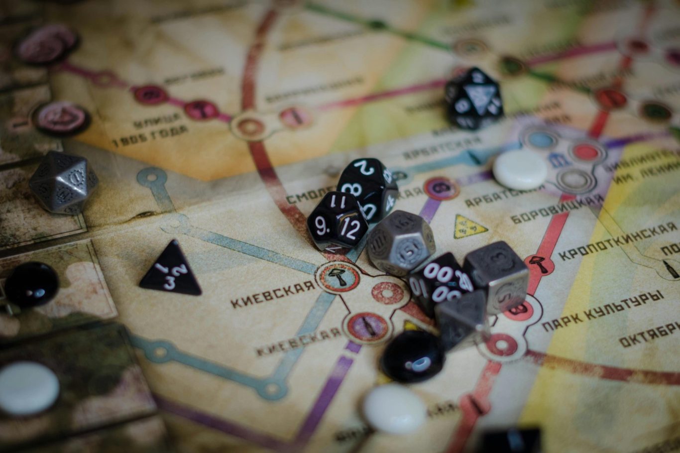 Close-up of a colorful game board with various dice and playing pieces scattered.