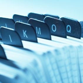 Close-up of alphabetically arranged file tabs in a blue-toned setting.